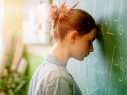 Girl with head on chalk board