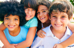 Portrait,Of,Multi-cultural,Children,Hanging,Out,With,Friends,In,Countryside